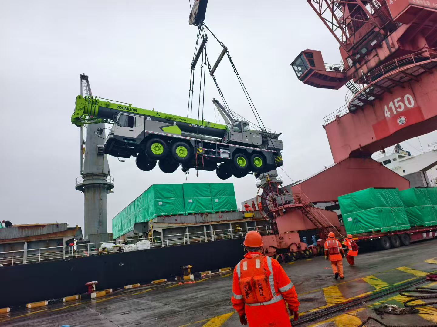 Zoomlion truck crane with red and white color scheme, positioned on road with urban background, professional construction equipment photography