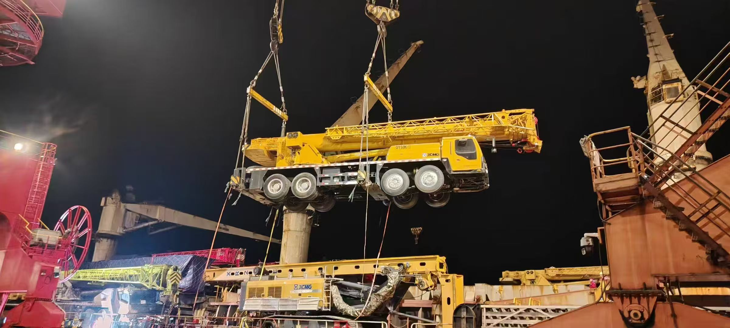 Modern construction site with multiple heavy machinery in operation, bright lighting, blue sky background
